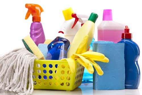 Professional carpet cleaner working with safety measures in Bow