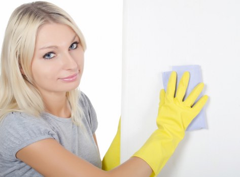 Local technician cleaning a mattress in a Bow bedroom